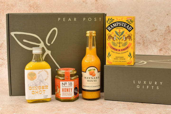 On The Mend get well soon gift box with a ginger shot, ginger and turmeric honey, lemon and ginger tea and orange and clementine juice
