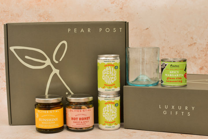 Spice Spice Baby gift box with two spicy margaritas, a blue recycled glass, chilli margarita rim salt, olives and hot honey nuts