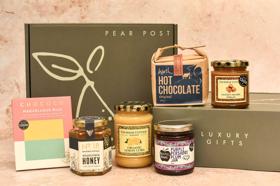 A Pear Post gift box with Chococo milk chocolate, No. 18 wildflower honey, Thursday Cottage lemon curd and salted caramel, Hårth hot chocolate and Fruits of the Forage plum jam